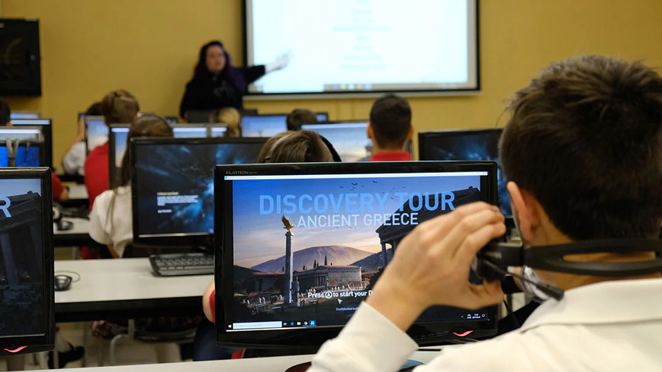 Image that shows a university classroom using the Ancient Greece Discovery Tour, with their lecturer presenting her own materials.